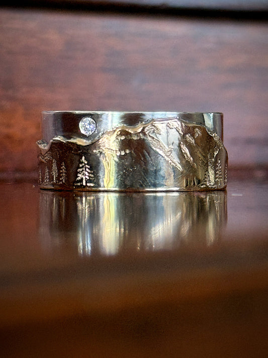 custom denali mountain wedding band in 14k gold and sterling silver with flush set diamond