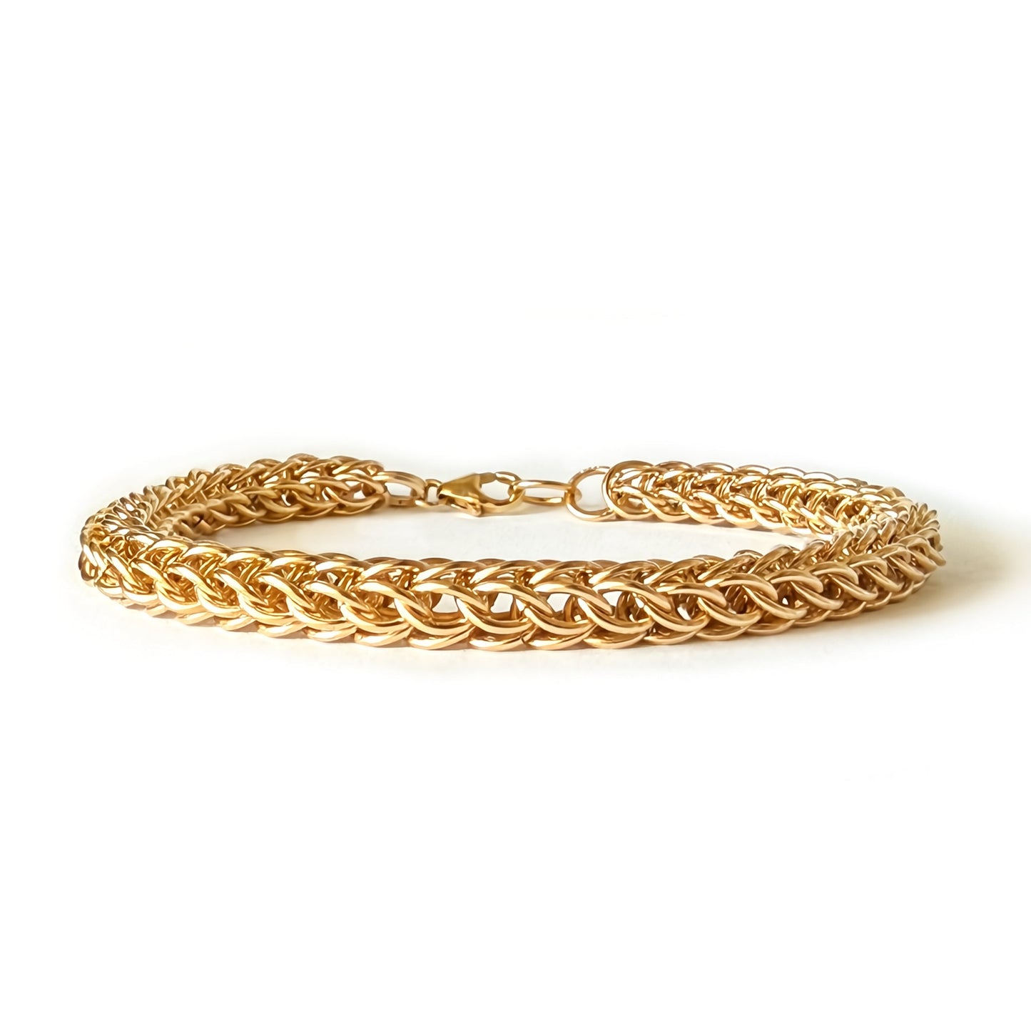Gold bracelet on a white background