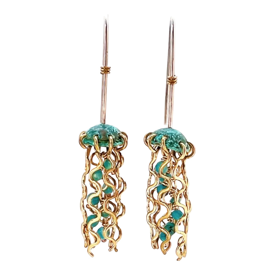 Jellyfish-shaped earrings with gold frames and turquoise stones on a white background