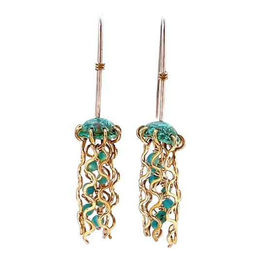 Jellyfish-shaped earrings with gold frames and turquoise stones on a white background