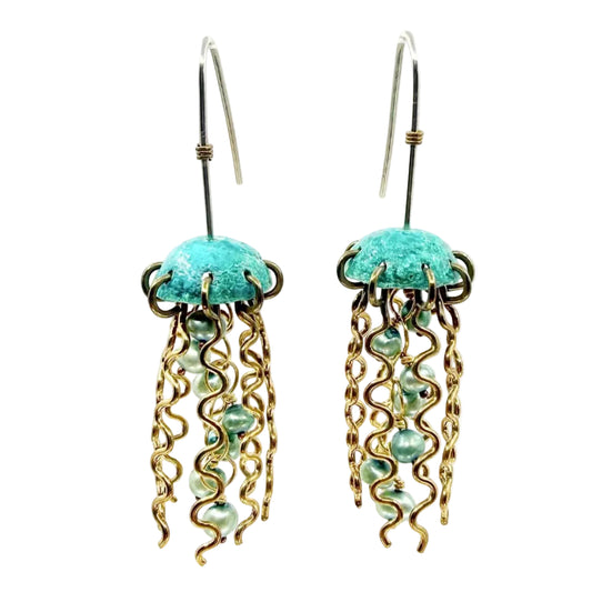 jellyfish earrings with green copper tops, squiggly brass legs, and green pearl centers on a white background